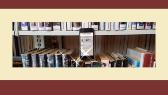 cell phone on a bookshelf with books with app open 