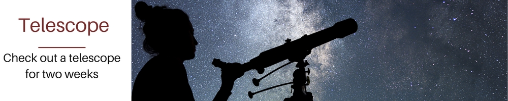 person at night with telescope