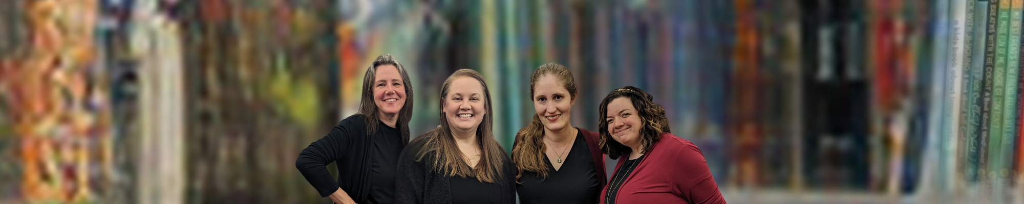 children's services staff in front of books