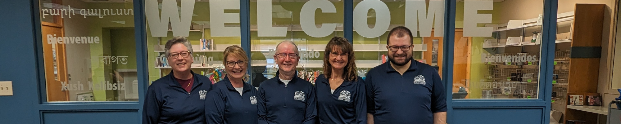 circulation staff in front of desk smiling