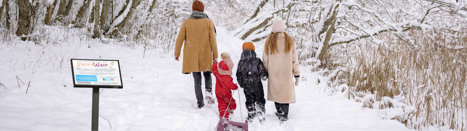 family walking in park in wintertime