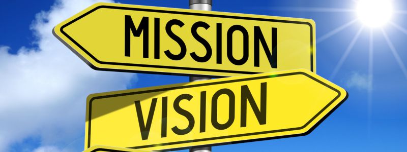 Yellow arrow signs with Mission & Vision written on them