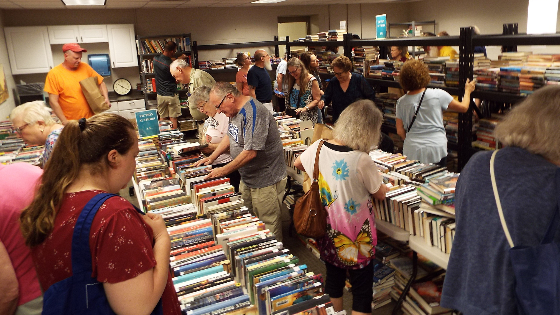 people at book sale choosing books